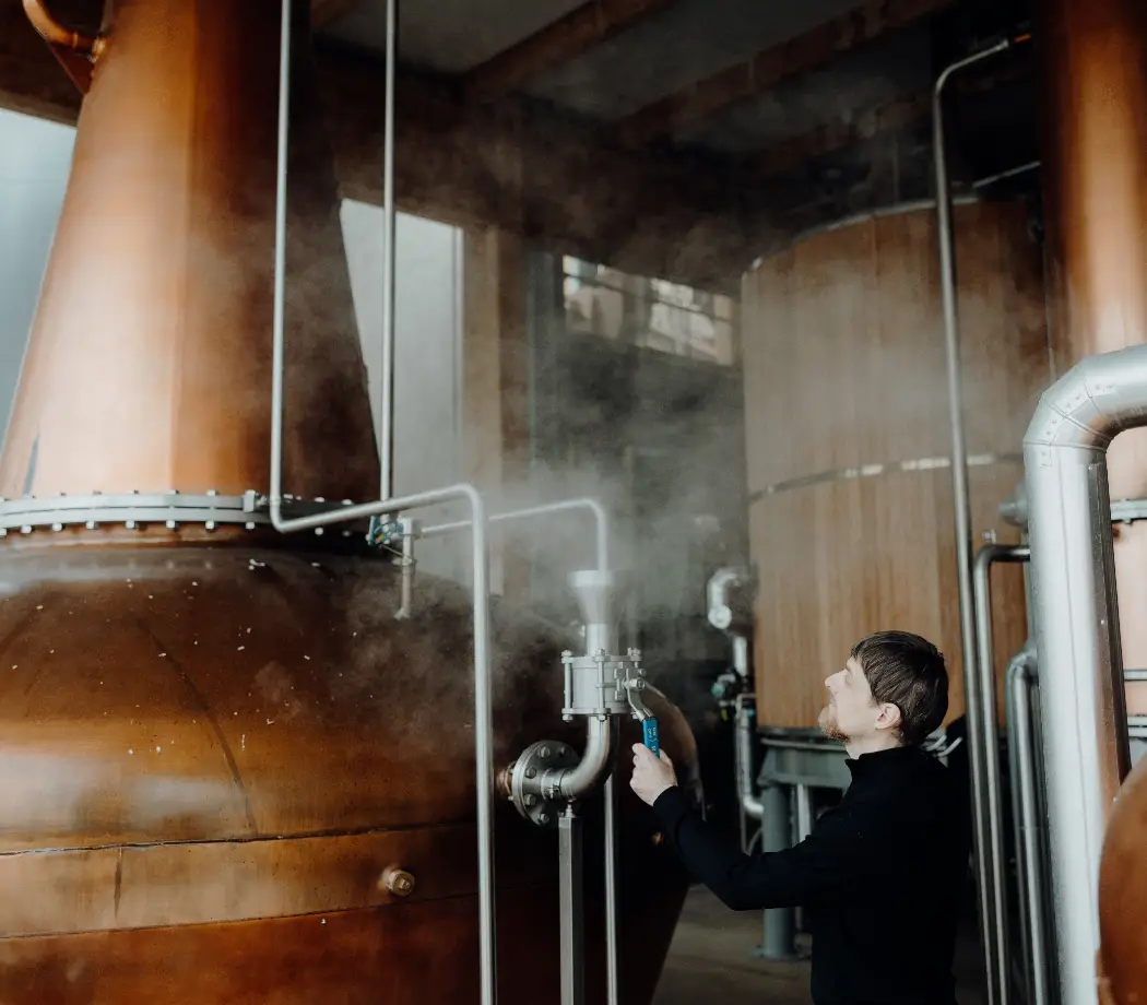 man at whiskey still