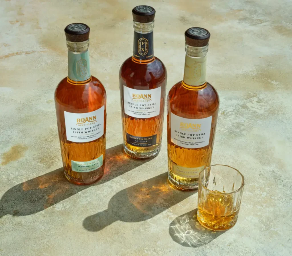 three bottles of whiskey glass