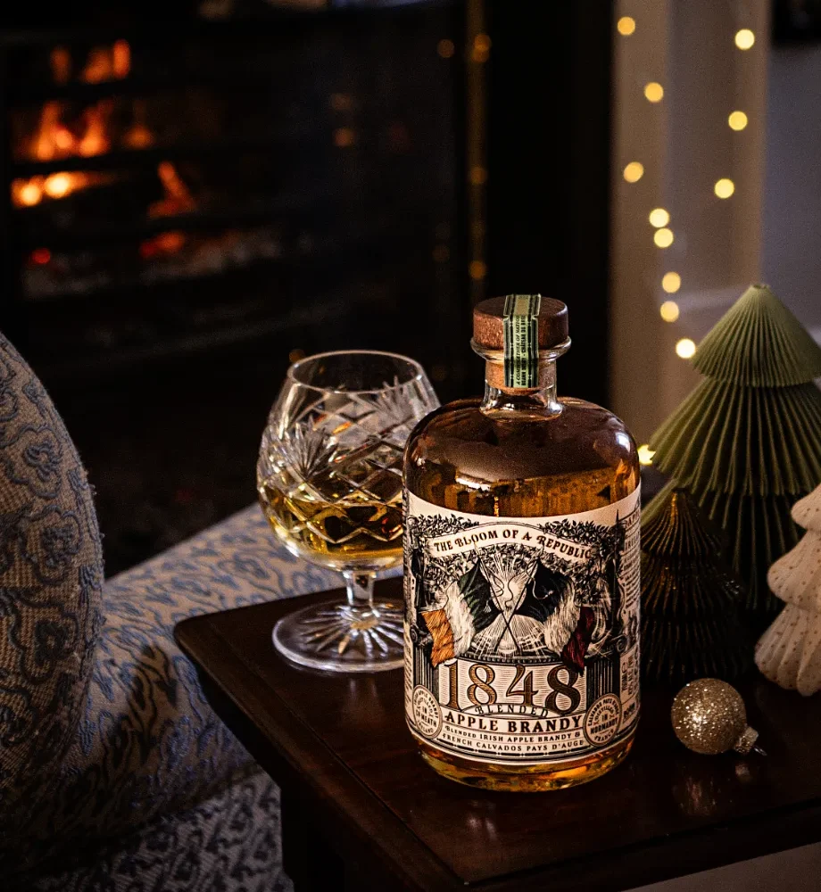 1848 apple brandy with glass by fireplace